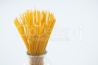 Raw spaghetti in arranged in glass container