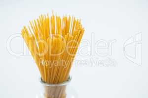 Raw spaghetti in arranged in glass container