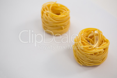 Tagliatelle pasta on white background