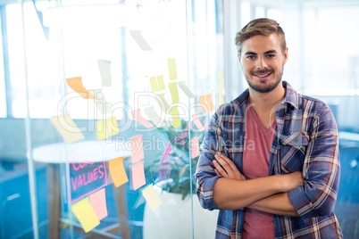 Man standing next to the sticky notes on wall in office