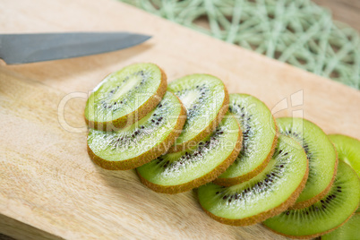Slices of kiwi on chopping board
