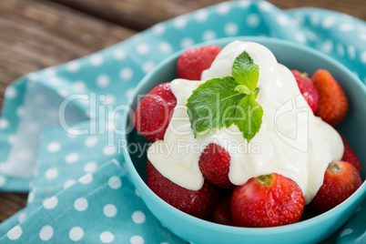 Close-up of fresh strawberries with cream in bowl