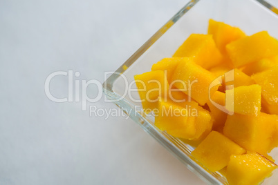 Close-up of chopped mangoes in glass bowl