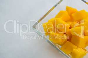 Close-up of chopped mangoes in glass bowl