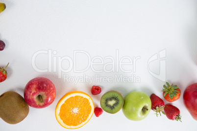 Various types of fruits arranged on white background