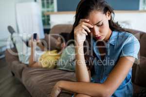 Couple ignoring each other in living room