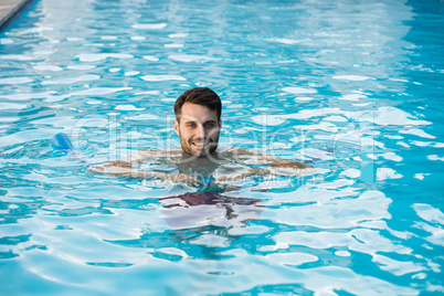 Young man swimming with inflatable tube