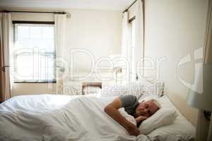 Senior man sleeping in the bedroom