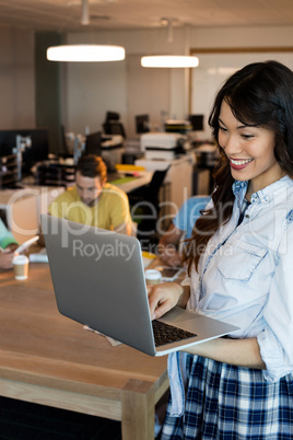 Woman using laptop at office