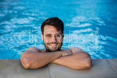 Portrait of young man relaxing in the pool
