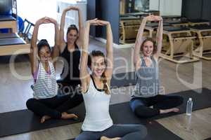 Portrait of fit women performing stretching exercise