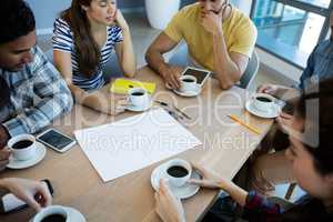 Creative business team having meeting over coffee in meeting room