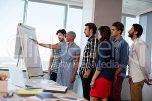 Woman giving presentation to her colleagues