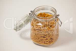 Macaroni pasta in a jar with open lid