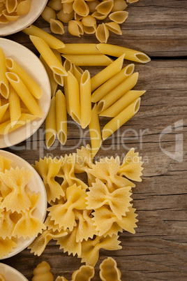 Varieties of pasta spilling out of spoons