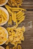Varieties of pasta spilling out of spoons
