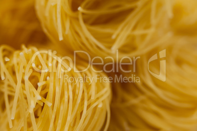 Tagliatelle pasta on wooden surface