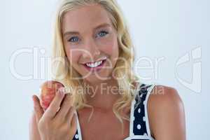 Portrait of beautiful woman holding red apple