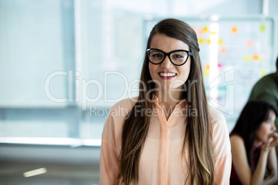 Woman in spectacles smiling in office