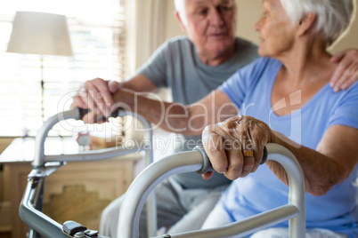 Senior man consoling woman in bedroom