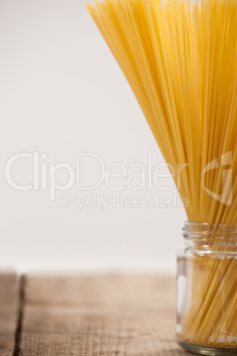 Bundle of raw spaghetti in glass jar