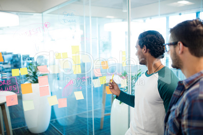 Creative business team looking at sticky notes and discussing