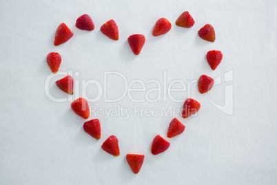 Red strawberries forming a heart shape