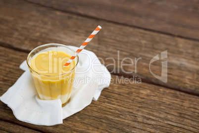 Fresh glass of smoothie with straw