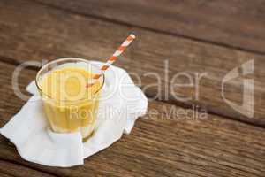 Fresh glass of smoothie with straw