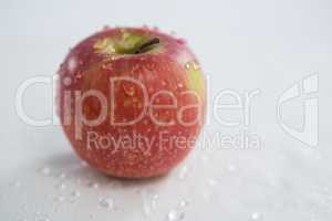 Red apple with water droplets