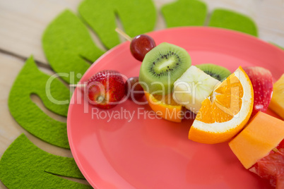 Close-up of fruit skewers in plate