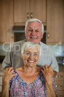 Portrait of happy senior couple in kitchen