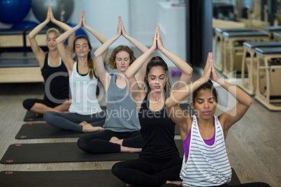 Group of women performing yoga