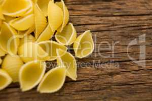 Conchiglie pasta on wooden surface
