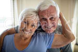 Portrait of senior couple embracing each other in the bedroom