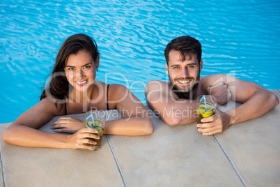 Portrait of young couple relaxing in the pool