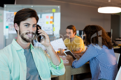 Man talking on his mobile phone at office