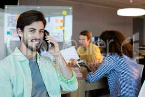 Man talking on his mobile phone at office