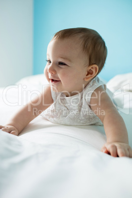 Cute smiling baby girl on bed