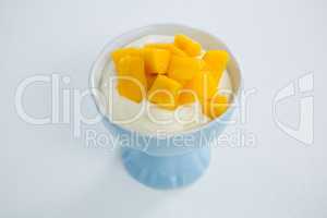 Chopped mangoes with cream in bowl