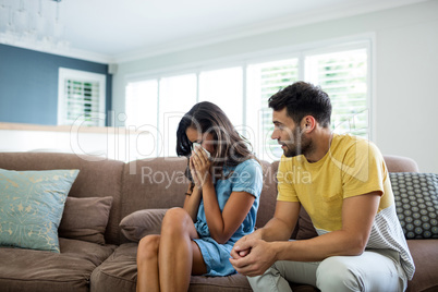 Couple arguing with each other in living room