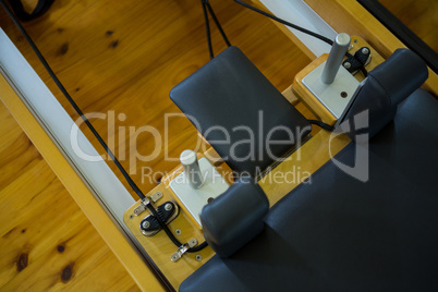 Close-up of reformer on wooden floor Close-up of reformer on wooden floor