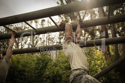 Soldier climbing monkey bars