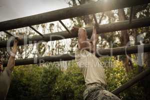 Soldier climbing monkey bars