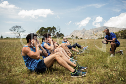 Fit people performing crunches exercise