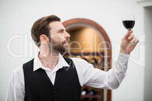 Male waiter holding wine glass