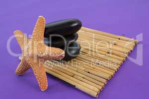 Zen stones with star fish on bamboo mat