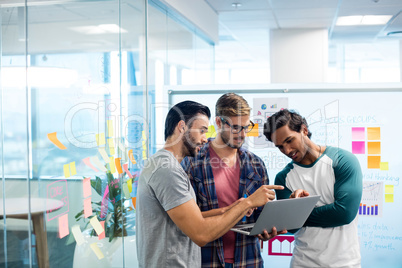 Creative business team discussing over the laptop