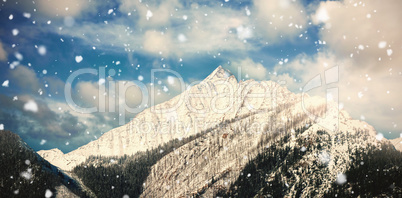 Snowy mountain range against blue sky 3d
