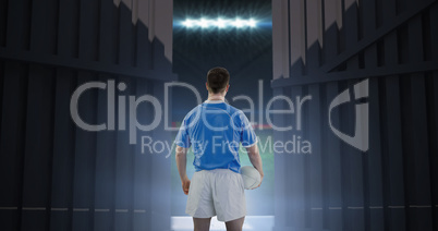 Composite image of rugby player holding a rugby ball 3d